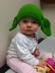 Baby wearing a Yoda hat